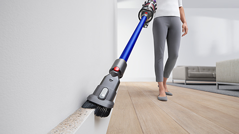 Using a Combination Tool to dust and clean the top of a wainscot.